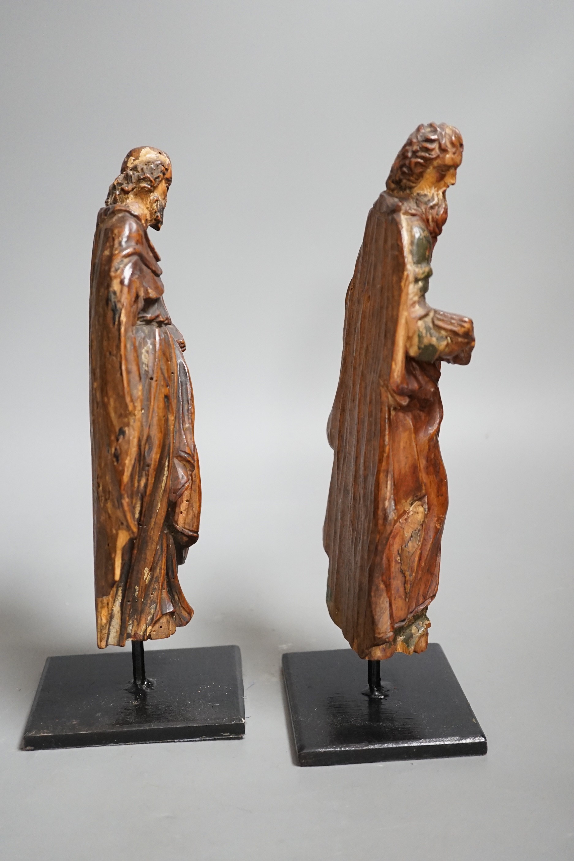 A pair of 17th century carved and painted pine figures. Tallest 26cm